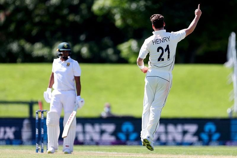 New Zealand's paceman Matt Henry (R) celebrates the wicket of South Africa's Kagiso Rabada during day one of the first cricket Test match between New Zealand and South Africa at Hagley Oval in Christchurch on 17 February, 2022