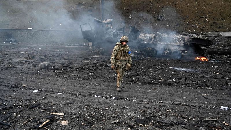 A Ukrainian service member is seen at the site of a fighting with Russian raiding group in the Ukrainian capital of Kyiv in the morning of 26 February, 2022