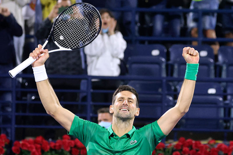 Novak Djokovic of Serbia celebrates after winning the ATP Dubai Duty Free Tennis Championship round of 32 match against Lorenzo Musetti of Italy in the Gulf emirate of Dubai on 21 February, 2022