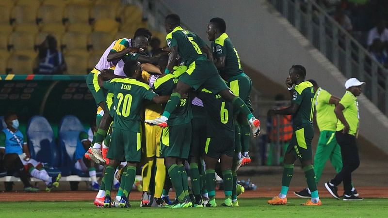 Senegal's players celebrate their team's first goal during the Africa Cup of Nations (CAN) 2021 semi final football against Burkina Faso at Stade Ahmadou-Ahidjo in Yaounde on 2 February, 2022