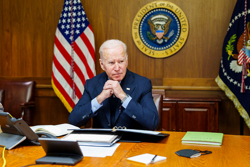 In this image released by the White House, US President Joe Biden speaks with Russian President Vladimir Putin from the presidential retreat in Camp David, Maryland, on 12 February 2022