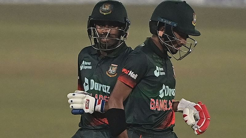 Bangladesh's Mehidy Hasan Miraz (L) with Afif Hossain during the first one-day international (ODI) cricket match between Afghanistan and Bangladesh at the Zahur Ahmed Chowdhury Stadium in Chittagong on 23 February, 2022