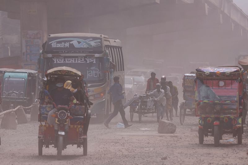 Vehicles are moving on a dusty road as air pollution worsens during winters in Tongi area of Gazipur, Bangladesh, on 3 February 2022