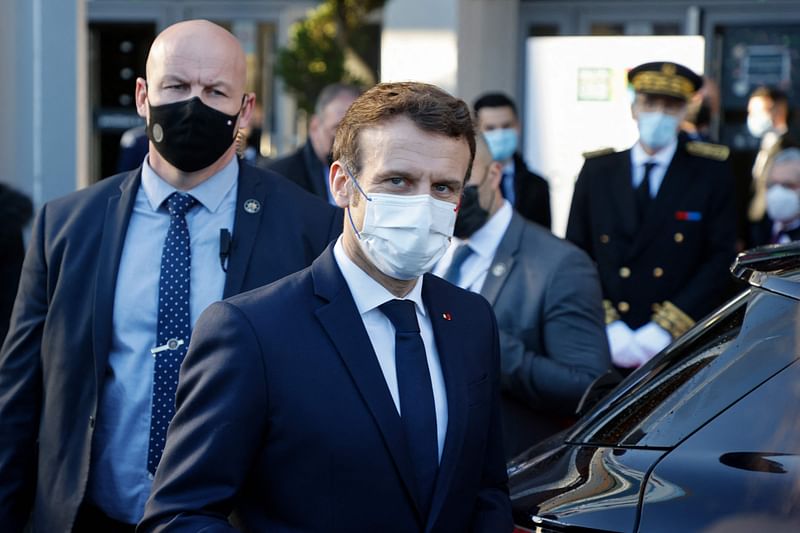 France's President Emmanuel Macron looks on as he leaves the 58th International Agriculture Fair (Salon de l'Agriculture) at the Porte de Versailles exhibition centre in Paris, on 26 February, 2022