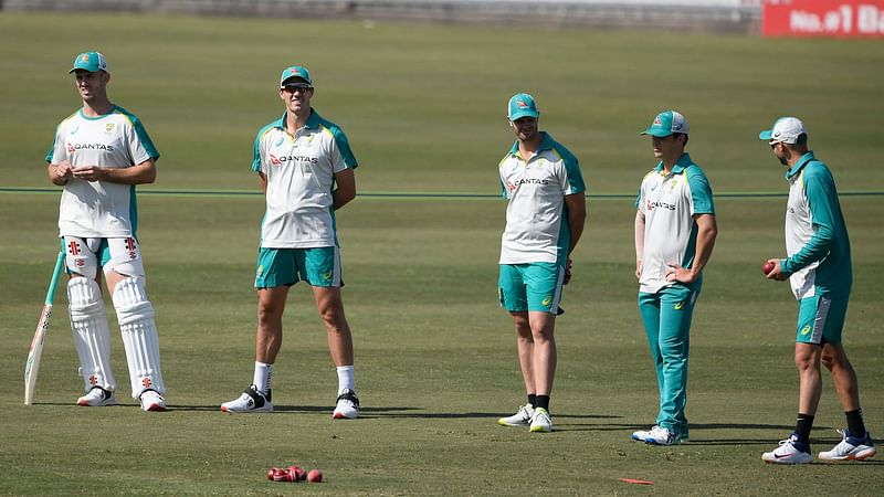 Australia's captain Pat Cummins (L) stands with teammates during a practice session at the Rawalpindi Cricket Stadium in Rawalpindi on 1 March, 2022, ahead of the first cricket Test match between Pakistan and Australia