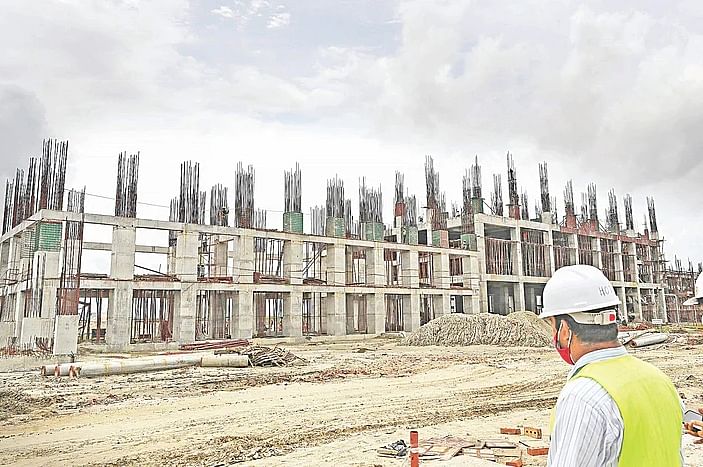 An engineer surveys an under construction building at the Bangabandhu Sheikh Mujib Shilpa Nagar