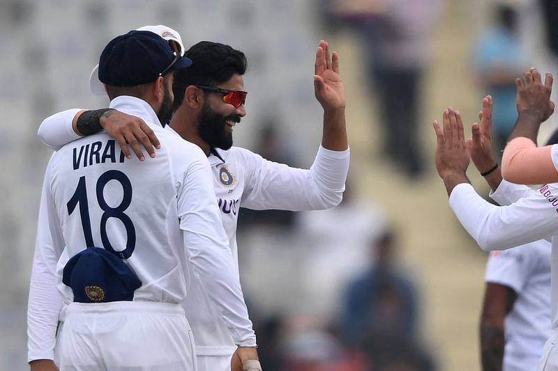 India's Ravindra Jadeja (2L) celebrates with teammates after the dismissal of Sri Lanka's Lahiru Kumara during the third day of the first Test cricket match between India and Sri Lanka at the Punjab Cricket Association Stadium in Mohali on 6 March, 2022