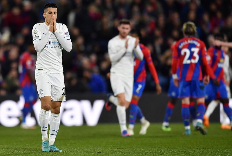 Manchester City's Portuguese defender Joao Cancelo (L) reacts after failing to score during the English Premier League football match between Crystal Palace and Manchester City at Selhurst Park in south London on 14 March, 2022