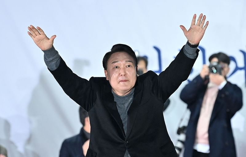 Yoon Suk-yeol of the main opposition People Power Party gestures to supporters during an election campaign rally in Seoul on 8 March, 2022, ahead of the 9 March presidential election