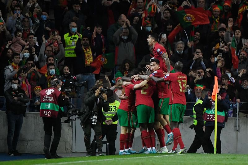 Portugal's players celebrate after scoring a goal during the World Cup 2022 qualifying final first leg football match between Portugal and North Macedonia at the Dragao stadium in Porto on 29 March, 2022