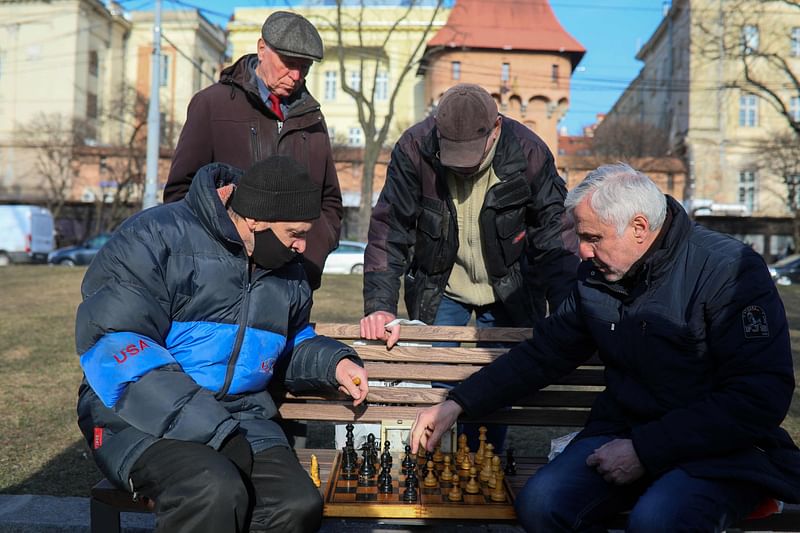 Men play chess at a bench on the central promenade in the western Ukrainian city of Lviv on 20 March, 2022