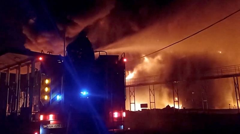 A fire engine extinguishes fire in an oil depot that Ukraine's State Emergency Services say was caused by Russian strikes in Zhytomyr region, Ukraine on 7 March, 2022 in this still image obtained from a handout video.