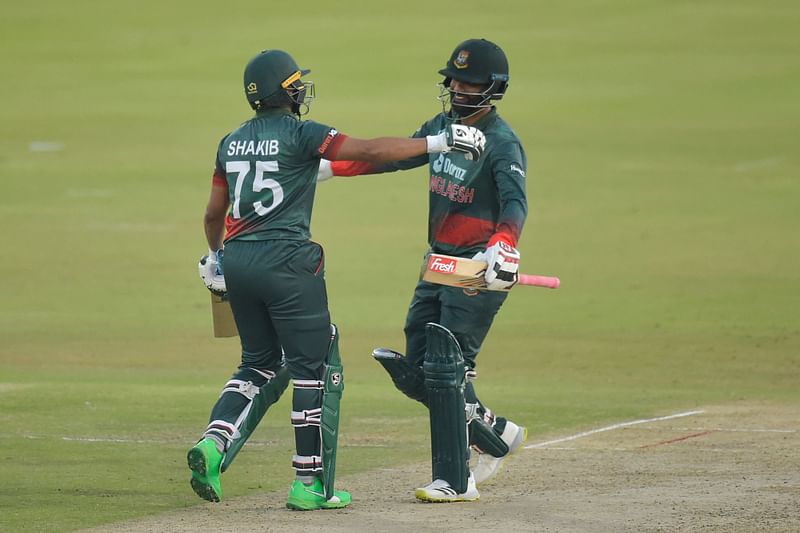 Bangladesh's Shakib Al Hasan (L) and Bangladesh's Tamim Iqbal (R) celebrate after Bangladesh won the third one-day international (ODI) cricket match between South Africa and Bangladesh at SuperSport Park in Centurion on 23 March 2022