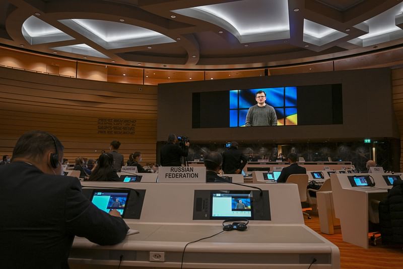 Ukraine's foreign minister Dmytro Kuleba is seen on a TV screen while addressing with a pre-recorded video message the Conference on Disarmament in Geneva on 1 March 2022