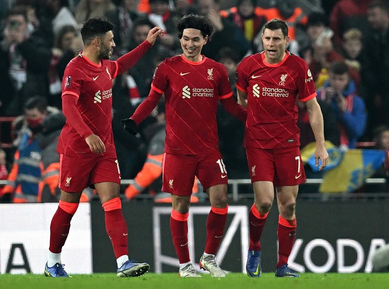 Liverpool's Japanese midfielder Takumi Minamino (C) celebrates scoring his team's second goal with teammates during the English FA Cup fifth round football match against Norwich City at Anfield in Liverpool, northwest England on 2 March, 2022