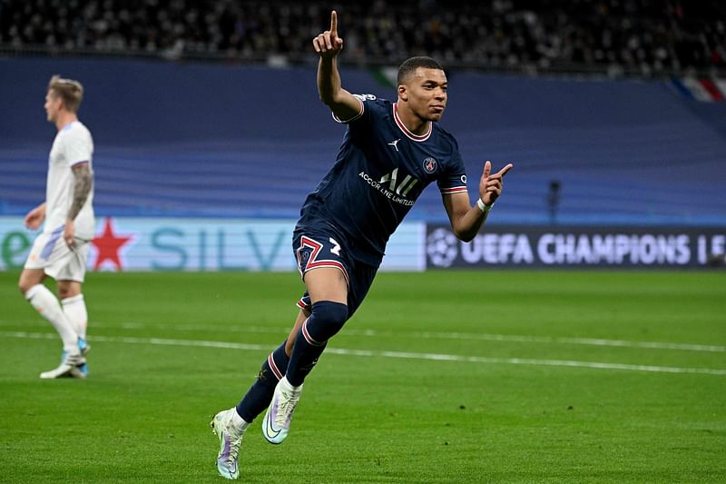 aris Saint-Germain's French forward Kylian Mbappe celebrates scoring his team's first goal during the UEFA Champions League round of 16 second league football match between Real Madrid CF and Paris Saint-Germain at the Santiago Bernabeu stadium in Madrid on 9 March, 2022