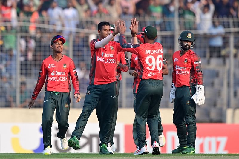 Bangladesh's players celebrate after the dismissal of Afghanistan's Darwish Rasooli (not pictured) during the first Twenty20 international cricket match between Bangladesh and Afghanistan at the Sher-e-Bangla National Cricket Stadium in Dhaka on 3 March, 2022