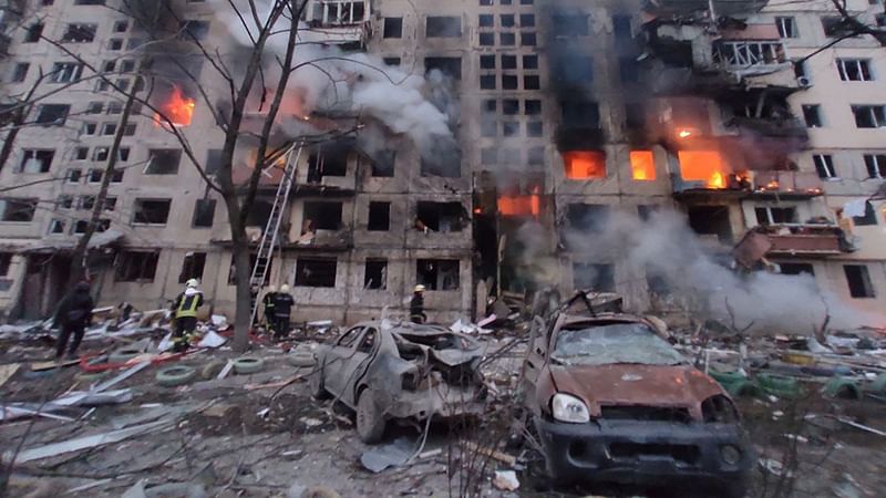 In this handout picture taken and released by the State Emergency Service of Ukraine on 14 March 2022, firemen work to extinguish a fire in an apartment building hit by shelling in the Obolon district of Kyiv.