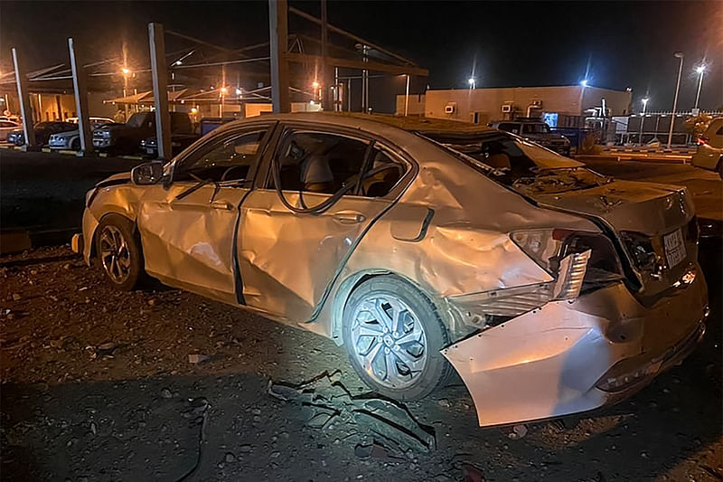 This handout image released by the Saudi press Agency (SPA) shows a damaged car parked at an Aramco oil terminal in the southern Saudi border town of Jizan on 20 March, 2022, following a "drone assault" the previous day on a petroleum products distribution terminal run by Aramco