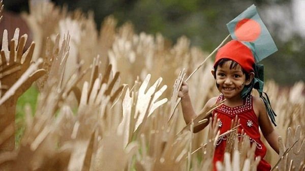 A child runs with a flag of Bangladesh