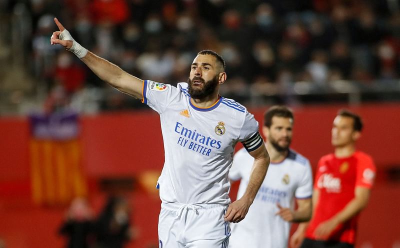 Real Madrid's French forward Karim Benzema celebrates after scoring a goal during the Spanish League football match between RCD Mallorca and Real Madrid CF at the Son Moix stadium in Palma de Mallorca on 14 March, 2022