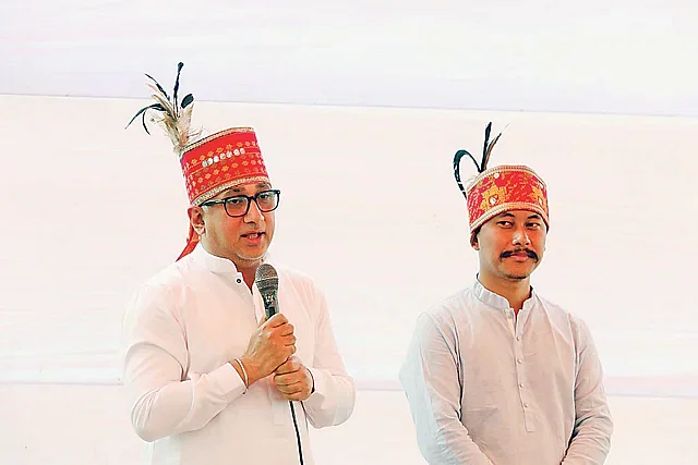 Grameenphone CEO Yasir Azman wears the Garo crown of honour 'kutub'. Next to him is Subir Nokrek. The picture was taken on Saturday at the village Gary in Modhupur.