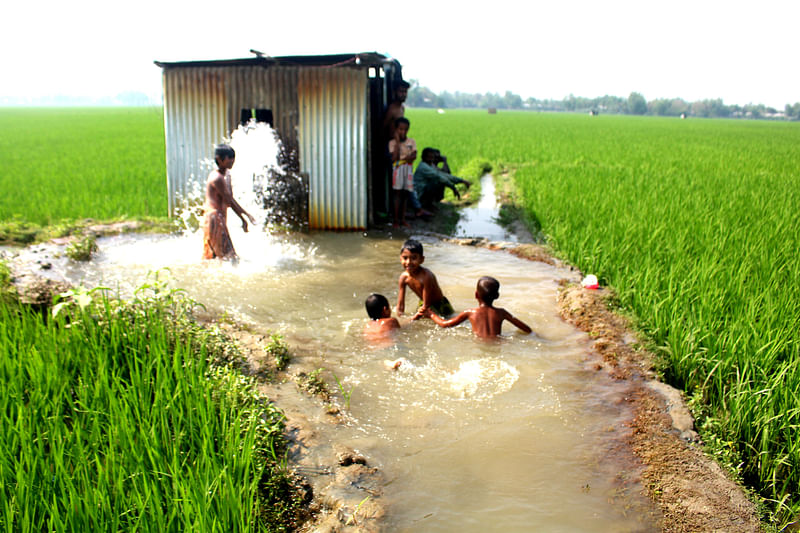 Children take shower at irrigation pump water. The picture was taken from Borobaria in Sarishabari of Jamalpur on 16 March.