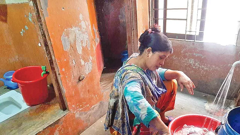 Chicken, lentils and other foodstuff is washed in front of the latrine at the street children's centre