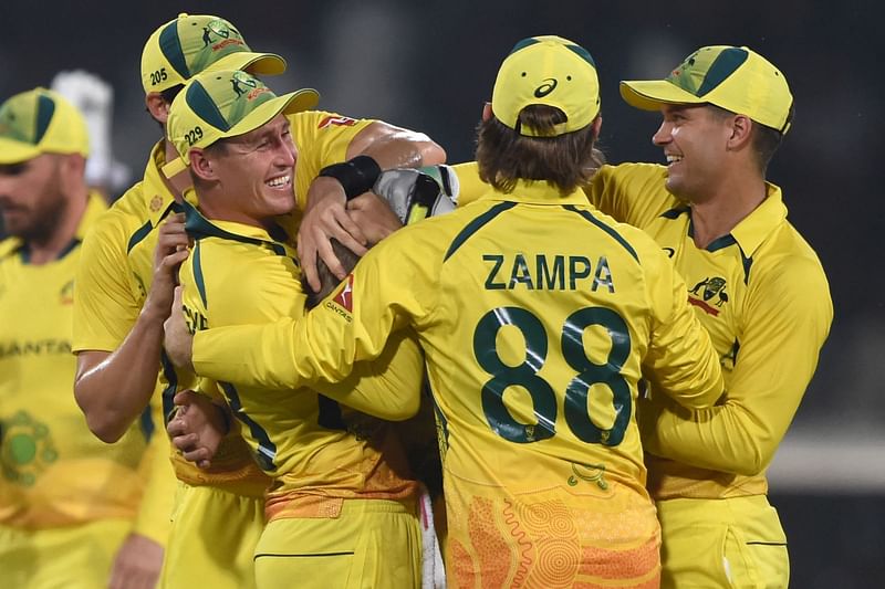 Australia's players celebrate after dismissal of Pakistan's Imam-ul-Haq (L) during the first one-day international (ODI) cricket match between Pakistan and Australia at the Gaddafi Cricket Stadium in Lahore on 29 March, 2022