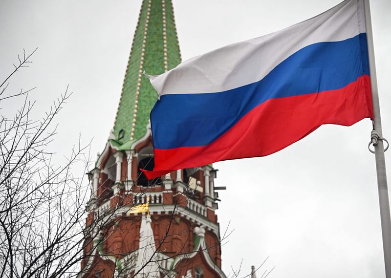 A Russian flag waves next to one of the Kremlin towers in downtown Moscow on 26 February, 2022