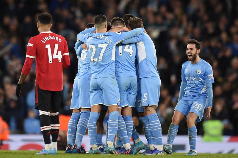 Manchester City's Algerian midfielder Riyad Mahrez celebrates after scoring their third goal during the English Premier League football match between Manchester City and Manchester United at the Etihad Stadium in Manchester, north west England, on 6 March, 2022