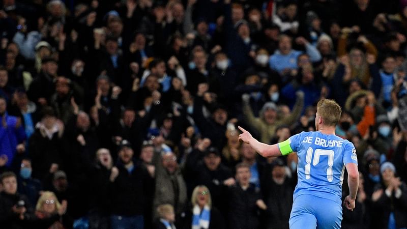 Manchester City's Belgian midfielder Kevin De Bruyne celebrates after scoring the opening goal of the UEFA Champions League Quarter-final first leg football match between Manchester City and Atletico Madrid at the Etihad Stadium in Manchester, north west England, on 5 April, 2022