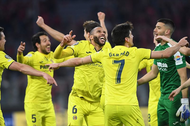 Villarreal players celebrate after the UEFA Champions League quarter-final, second leg football match FC Bayern Munich v FC Villarreal in Munich, southern Germany on 12 April, 2022