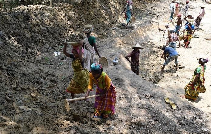 Men and women workers re-excavate ponds in Barind area to use surface water and lessen pressure on underground water