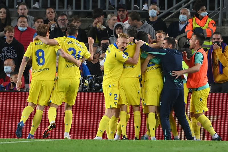 Cadiz's players celebrate after Spanish forward Lucas Perez scored a goal during the Spanish League football match between FC Barcelona and Cadiz CF at the Camp Nou stadium in Barcelona on 18 April, 2022