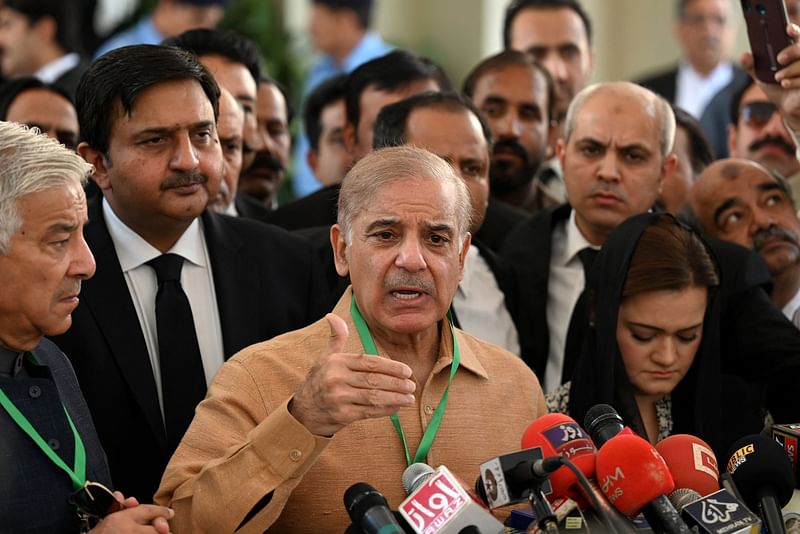 Pakistan's opposition leader Shehbaz Sharif (C) addresses the members of the media before attending a hearing outside the Supreme Court building in Islamabad on 5 April, 2022.