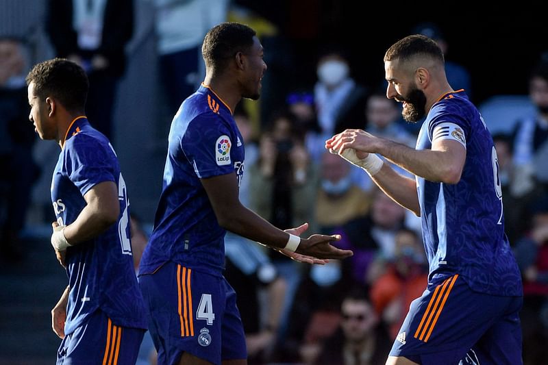 Real Madrid's French forward Karim Benzema (R) celebrates with teammate Real Madrid's Austrian defender David Alaba after scoring a second penalty during the Spanish League football match between RC Celta de Vigo and Real Madrid CF at the Balaidos stadium in Vigo on 2 April, 2022