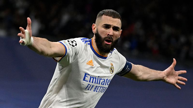 Real Madrid's French forward Karim Benzema celebrates after scoring a goal during the UEFA Champions League quarter final second leg football match between Real Madrid CF and Chelsea FC at the Santiago Bernabeu stadium in Madrid on 12 April, 2022