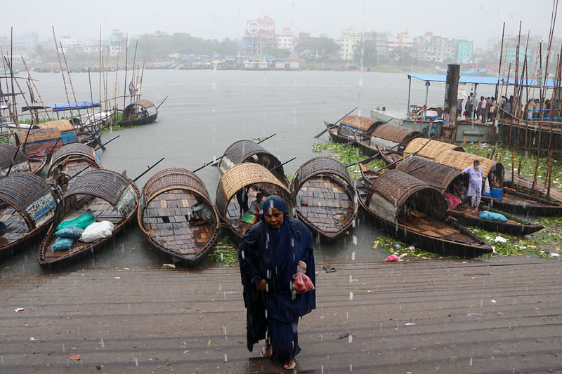 Boatmen sit idle as there is no passenger due to the rain. The picture was taken from central Kheyaghat in Narayanganj