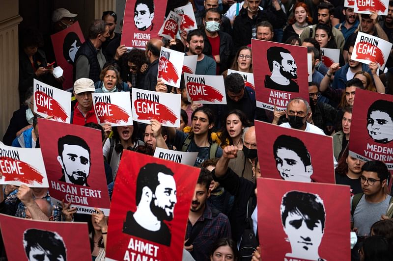 Protesters hold placards and shout slogans in Istanbul on 26 April 2022 during a rally in support of civil society leader Osman Kavala. A Turkish court sentenced on 25 April 2022, leading activist Osman Kavala to life in prison on controversial charges of trying to topple the government that had already seen him jailed without a conviction for more than four years.