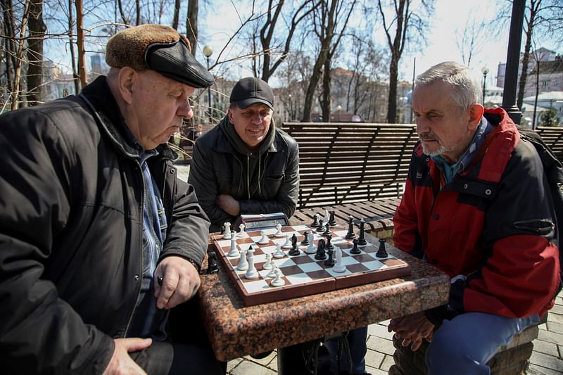 Two men play chess in a park, amid Russia's invasion of Ukraine, in Kyiv, Ukraine, April 7, 2022.