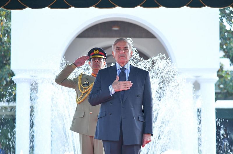 In this handout photograph released by the Press Information Department (PID) on 12 April, 2022, newly elected Pakistan Prime Minister Shehbaz Sharif receives guard of honour on his arrival in the Prime Minister House during a ceremony in Islamabad.