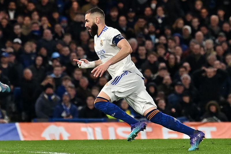 Real Madrid's French striker Karim Benzema celebrates after scoring his third goal during the UEFA Champions League Quarter-final first leg football match between Chelsea and Real Madrid at Stamford Bridge stadium in London, on 6 April, 2022