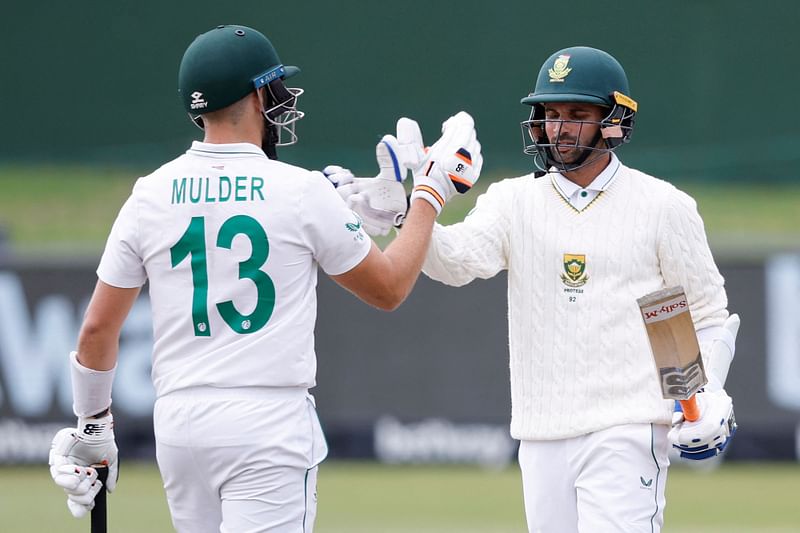 South Africa's Keshav Maharaj (R) is congratulated by Wiaan Mulder (L) after scoring a half-century during the second day of the second Test between South Africa and Bangladesh at St George's Park in Port Elizabeth on Saturday.