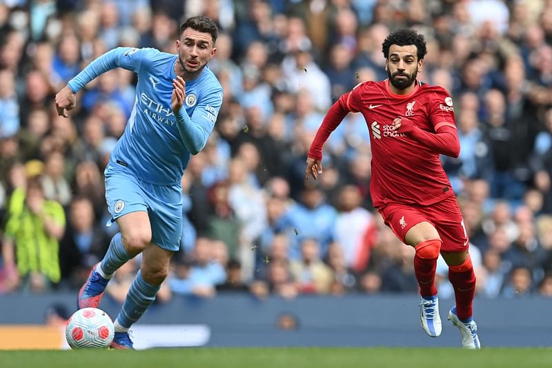 Liverpool's Egyptian midfielder Mohamed Salah (R) vies with Manchester City's French defender Aymeric Laporte during the English Premier League football match between Manchester City and Liverpool at the Etihad Stadium in Manchester, north west England, on 10 April, 2022