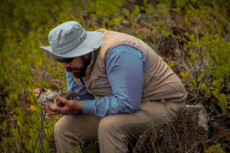 A scientist inspecting a rock at Mexico's remote Revillagigedo Islands, a group of four volcanic islands in the Pacific Ocean several hundred kilometres (miles) from the coast.