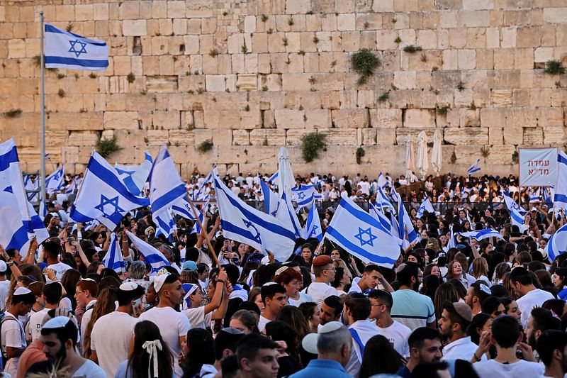 Demonstrators gather with Israeli flags at the Western Wall in the old city of Jerusalem on 29 May, 2022