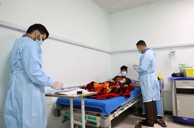 Doctors at a hospital in Iraq's southern Dhi Qar province, examine a patient infected with the tick-borne virus Crimean-Congo haemorrhagic illness (CCHF), on 25 May, 2022, during the country's worst detected outbreak of the illness.