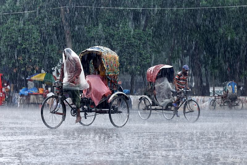 Rickshaws pass on the street as it rains in Dhaka, Bangladesh, on 10 May 2022