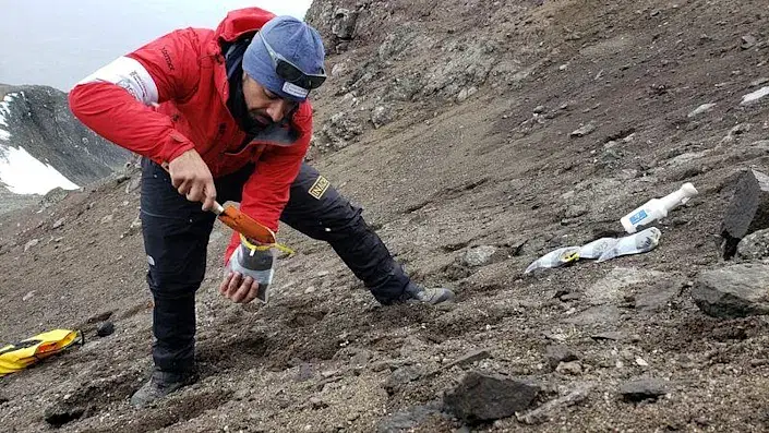 A scientist from the University of Chile collects organic material looking for a bacteria discovered in Antarctica.